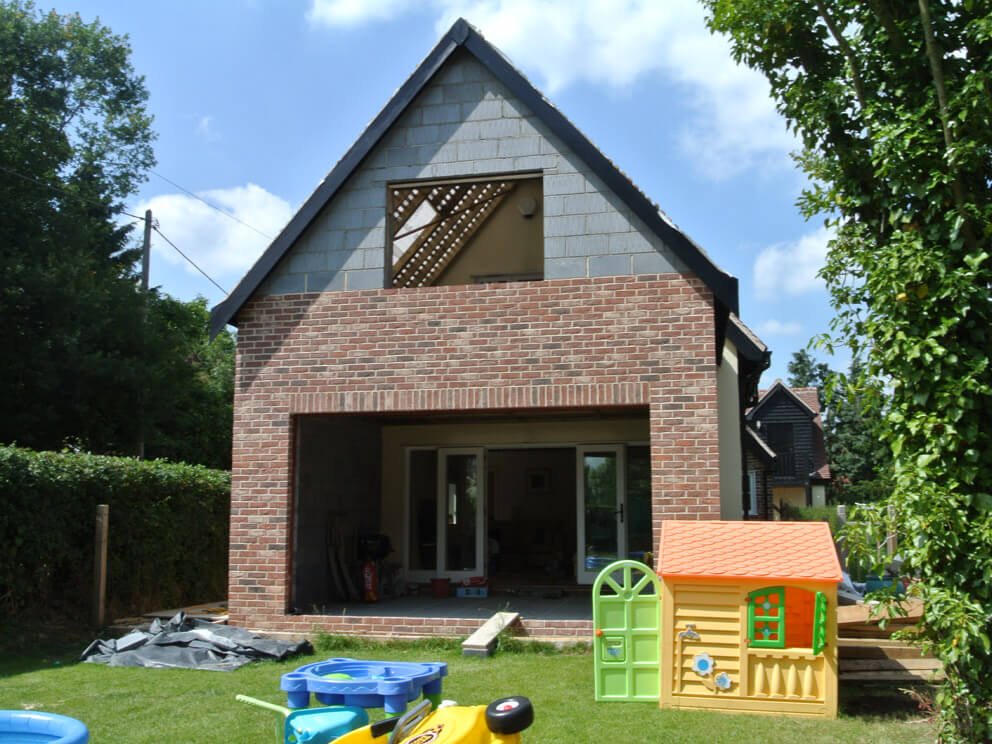 Brick extension with open garden-facing doors